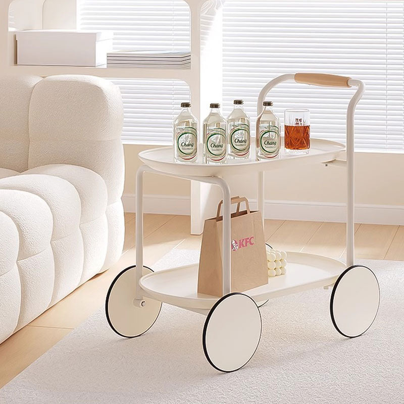 Modern minimalist trolley with wheels, used as a convenient side table or snack cart in a living room setup. Features an upper and lower shelf for drinks and snacks. Ideal for easy mobility and space organization. Bulk orders directly from China available.