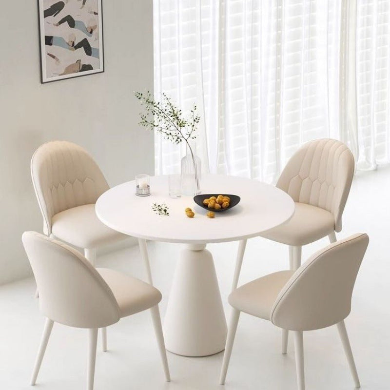 Round dining table with four upholstered chairs, ideal for dining rooms, cafés, and small spaces. Perfect for interior design projects and available for direct wholesale from China with customization options.