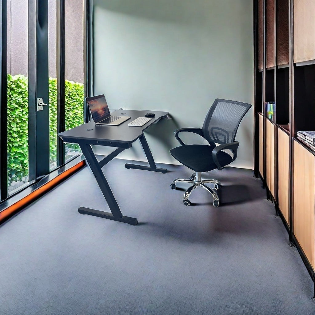 Modern office with a sleek gaming desk featuring a headphone hook and a breathable mesh chair, ideal for home offices, gaming setups, and professional workspaces. Perfect for businesses or individuals looking to purchase durable furniture directly from a Chinese manufacturer.