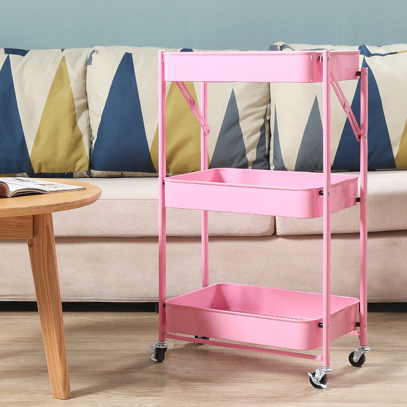 Two-tier mobile storage cart with caster wheels, placed in a living room setup for versatile home or office organization. Ideal for bulk purchases from Chinese suppliers, allowing for direct wholesale pricing benefits.