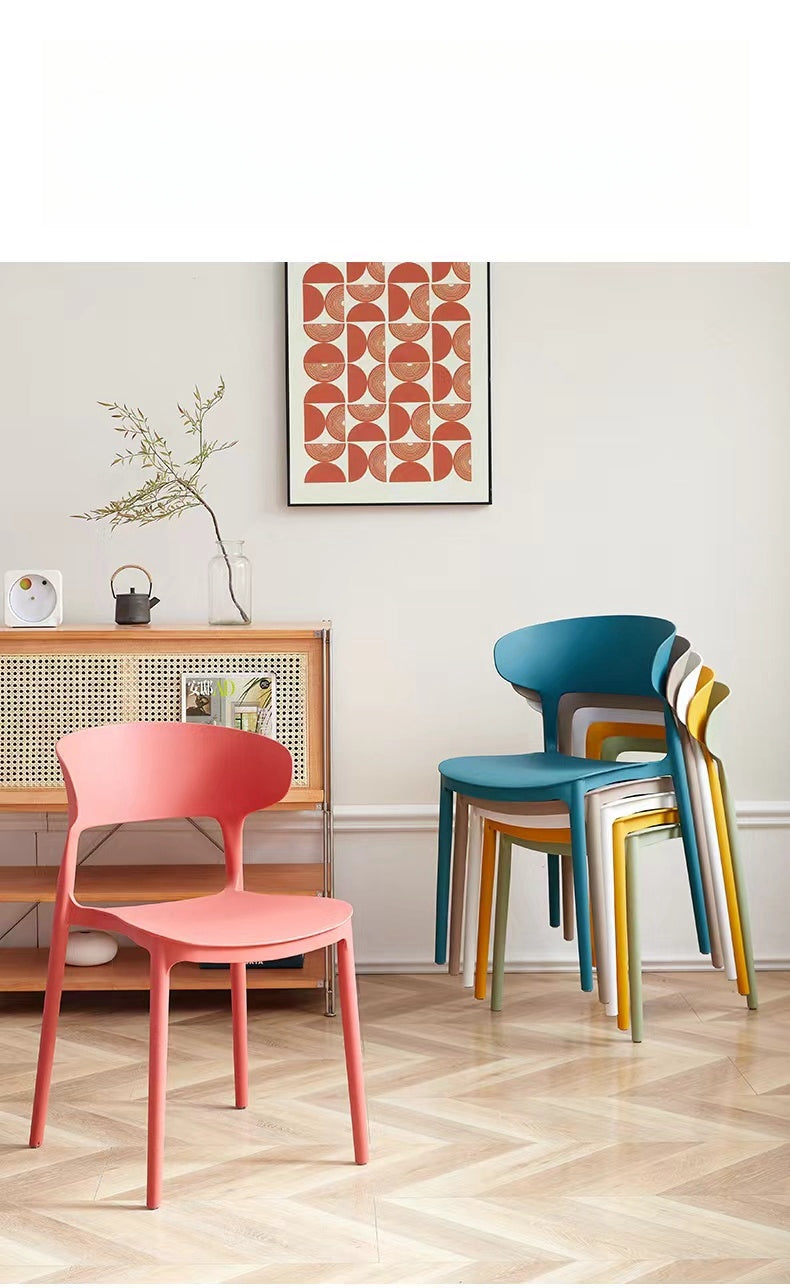 Stackable modern chairs displayed in a stylish home or café setting, ideal for large wholesale orders directly from a Chinese manufacturer for versatile use in dining areas, offices, or creative spaces.