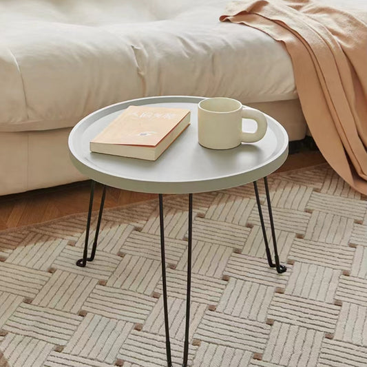 Round foldable coffee table placed in a modern living room setting, ideal for wholesale from a Chinese furniture supplier, offering versatility for residential or commercial spaces.