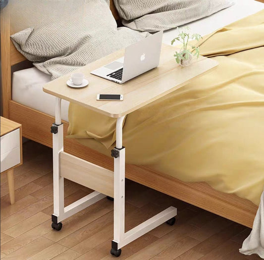 Adjustable bedside desk on wheels used as a laptop table in a bedroom setting, ideal for wholesale purchase directly from China manufacturers.