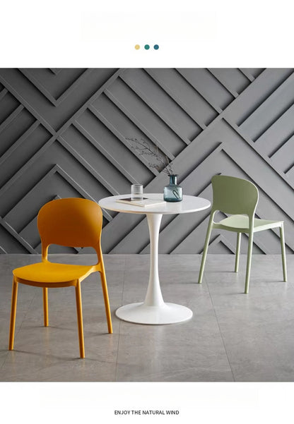 Modern dining chairs in a contemporary café setting, showcasing stackable design for easy storage and versatile use in residential or commercial spaces. Ideal for wholesale buyers sourcing directly from China.