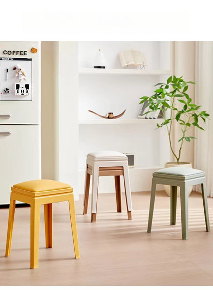 Stackable modern stools in a living space, ideal for dining rooms, kitchens, or commercial use; available for bulk wholesale directly from a Chinese supplier.