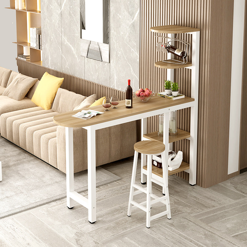 Compact bar table with integrated shelving for wine and decor, featuring seating options with a cushioned stool and a mesh-backed chair, ideal for small spaces such as living rooms or kitchens. Wholesale advantage from a leading Chinese manufacturer, offering competitive pricing.