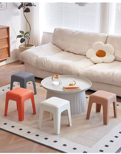 Multipurpose stools in a living room setting, ideal for residential and commercial spaces, featuring stackable design for space-saving. Perfect for bulk orders directly from a Chinese manufacturer.