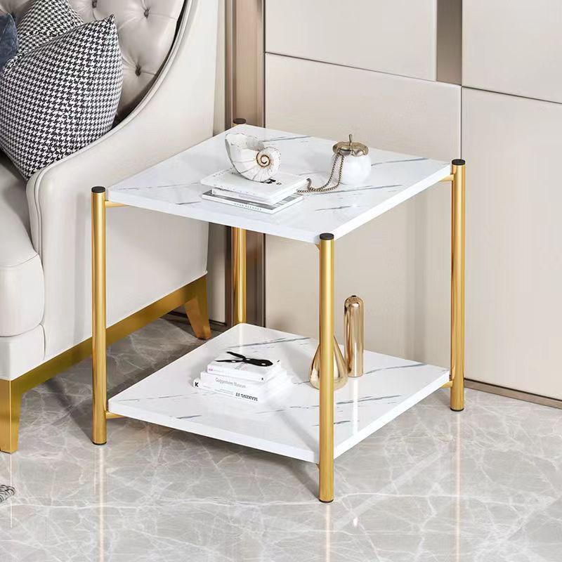 Square side table with two tiers, placed beside a sofa in a living room. Suitable for use as a coffee table or accent table. Ideal for wholesale buyers looking for bulk orders from China. Streamlined design, adaptable to modern interiors.