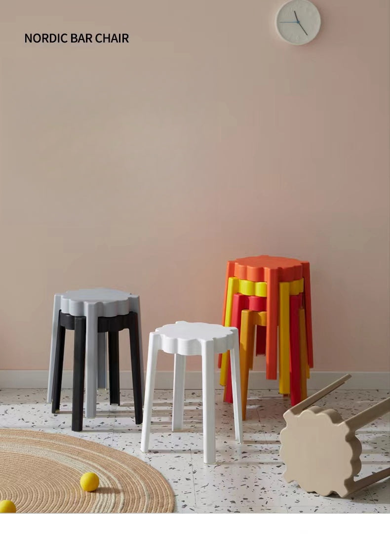 Stackable Nordic bar stools in a modern setting, ideal for cafes, restaurants, offices, and bulk purchases from China. Space-saving design suitable for contemporary environments.