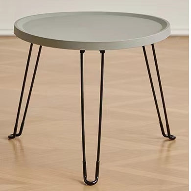 Round foldable coffee table with minimalist design, ideal for living rooms, bedrooms, or office spaces. Versatile for different uses such as an accent side table or display table. Suitable for wholesale buyers looking for affordable furniture directly from a Chinese manufacturer.