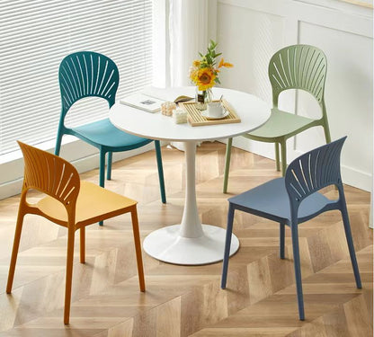 Stackable chairs around a dining table, ideal for cafes, restaurants, and patios. Perfect for wholesale buyers seeking stylish seating options directly from a Chinese manufacturer.