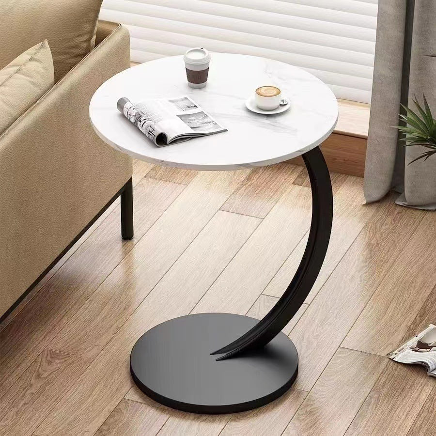 Modern round coffee table in a living room setting with a sofa and coffee cups, ideal for wholesale purchase directly from a Chinese manufacturer.