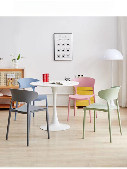 Modern stackable chairs arranged around a round table, ideal for dining areas, cafes, or office spaces. Perfect for bulk orders and direct sourcing from a Chinese manufacturer.