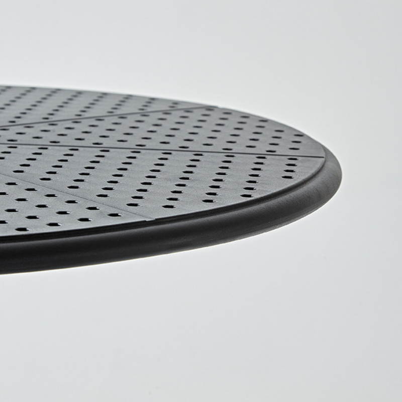 Close-up view of a sleek, perforated table surface, ideal for café, patio, and office use, designed for versatile indoor and outdoor applications. A top choice for buyers looking to wholesale furniture directly from a China-based manufacturer.