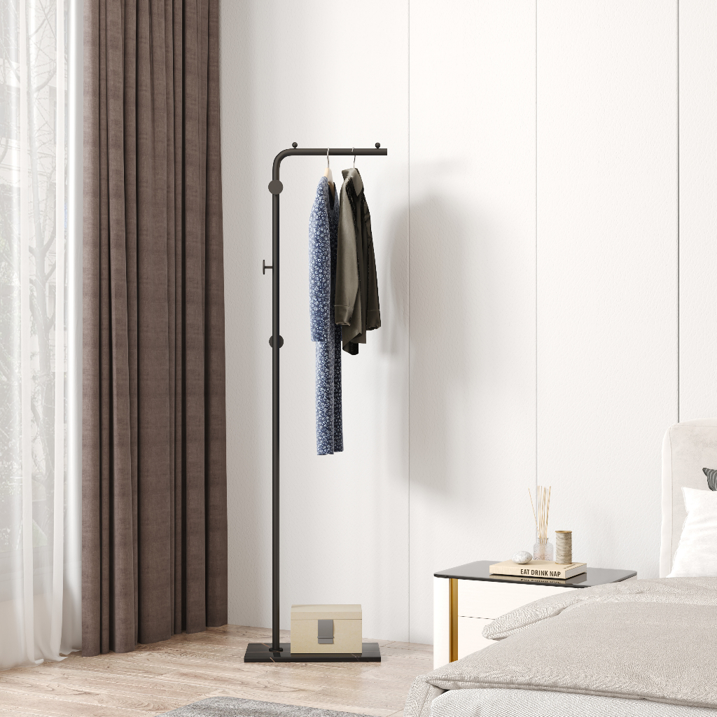 Coat stand in a modern bedroom setting, hanging shirts and a jacket, next to a leather chair and a side table. Perfect for space-saving organization. Wholesale from China available.