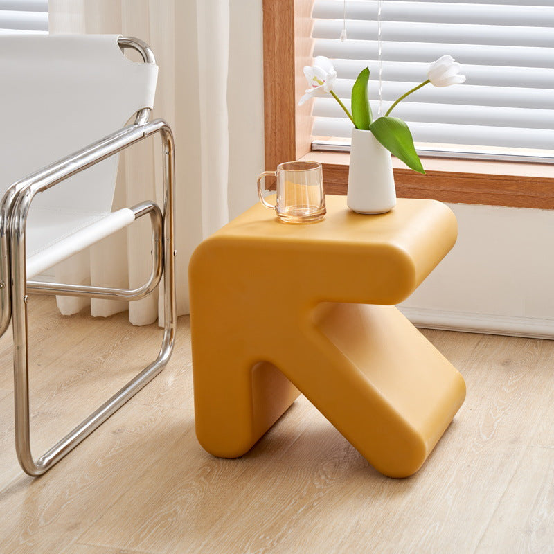 Modern leather chair and creative side table in a contemporary living room setup, showcasing minimalist design and versatile functionality for bulk direct import from China.