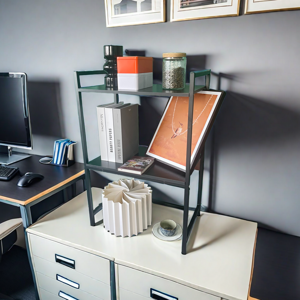 Office desk with a multi-layer storage rack holding books, decor, and small office supplies, highlighting versatile use in workspaces. Simplistic design optimized for compact vertical storage from a direct Chinese wholesaler.