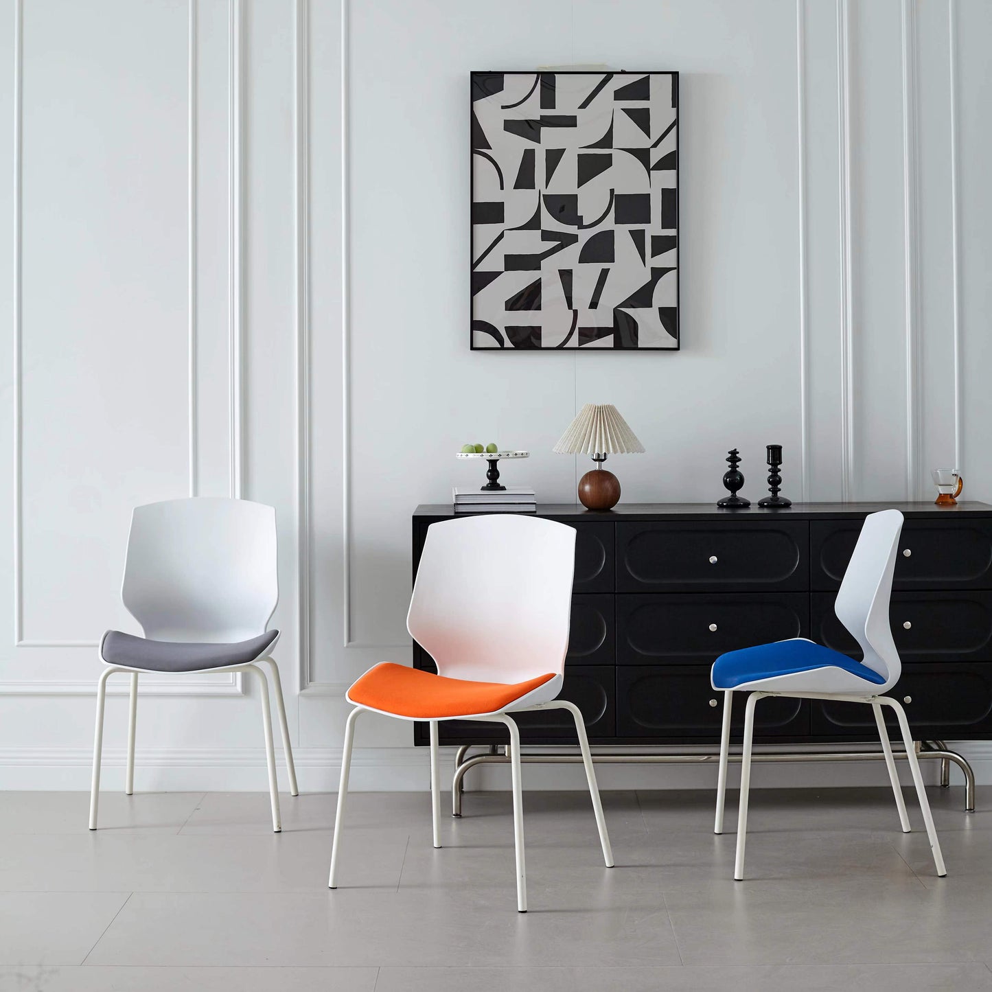 Three modern ergonomic chairs displayed in a stylish indoor setting, perfect for dining rooms, offices, or event spaces. Ideal for buyers sourcing wholesale from Chinese manufacturers with customizable options for bulk orders.