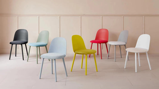 Dining chairs in various colors displayed in a minimalist room setting, showcasing versatile seating solutions suitable for dining areas, offices, and conference rooms. Ideal for wholesale purchase directly from Chinese manufacturers.