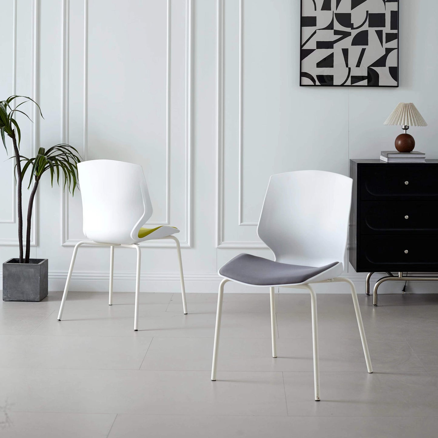 Two modern dining or office chairs in a stylish interior setting, showcasing sleek design ideal for versatile environments. Chairs available for wholesale directly from Chinese suppliers, perfect for both personal and commercial use.