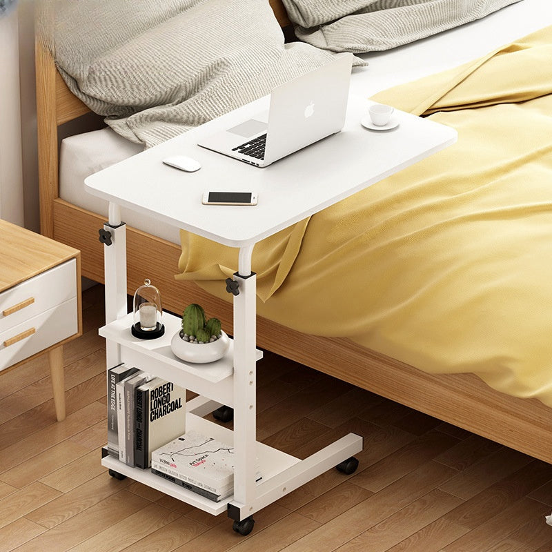 Adjustable mobile laptop desk used as bedside table with shelves for extra storage, ideal for home or office workspace, available for direct wholesale from Chinese manufacturer.