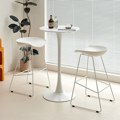 Modern home bar table with two bar stools, one upholstered and one with mesh, set in a minimalist indoor space. Ideal for cafes, restaurants, or home bars. Available for bulk orders directly from a Chinese manufacturer.